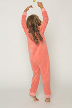 Load image into Gallery viewer, A child wearing a Sofa Killer peach unisex kids velours onesie, showcasing the soft and cozy design, with peach color cuffs and a playful pose against a neutral background.