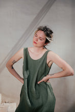 Load image into Gallery viewer, Model in a Women's dark green linen sleeveless dress Lola by SofaKiller, posing in a casual environment with a soft scoop neckline.