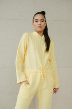 Load image into Gallery viewer, Model posing confidently in a Sofa Killer lime yellow linen women onesie, highlighting the chic style and natural fabric.