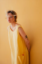 Load image into Gallery viewer, Close-up of the Women's yellow linen sleeveless dress Marisol by SofaKiller on a model, emphasizing the scoop neckline and the fabric texture.