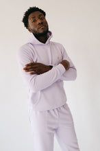 Load image into Gallery viewer, Model confidently poses in light violet Sofa Killer men hoodie Medusa, displaying the cozy fit and stylish look.