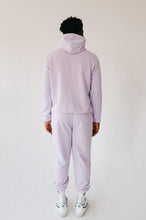 Load image into Gallery viewer, Back view of a man wearing the Sofa Killer men hoodie Medusa in light violet color, paired with matching trousers, showcasing a relaxed and stylish loungewear look.