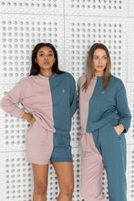 Load image into Gallery viewer, Close-up of two women in Sofa Killer two color lounge wear, showcasing the pink and blue design with embroidered logo, standing side by side.