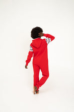Load image into Gallery viewer, Back view of a woman in a Sofa Killer red onesie with Nordic applications, demonstrating the stylish hoodie and elegant design.