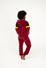 Load image into Gallery viewer, The back view of the Sofa Killer women velour onesie California in bordo, featuring a model with an afro hairstyle, highlighting its comfortable fit.