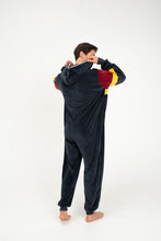 Load image into Gallery viewer, Back view of a man wearing the Sofa Killer velour onesie Kansas, showcasing the comfortable dark grey fabric with eye-catching red and yellow accents.