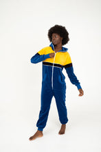 Load image into Gallery viewer, Sofa Killer women velour onesie Dakota showcasing royal blue and yellow color blocks, as a woman poses happily, ideal for casual outings and festivals.