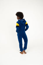 Load image into Gallery viewer, Back view of a model in Sofa Killer women velour onesie Dakota in royal blue, emphasizing the stylish hood and comfy fit.