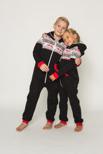 Load image into Gallery viewer, Sofa Killer black unisex kids onesie Nordic featuring two children in cozy, matching outfits with red cuffs and a white zipper, perfect for family gatherings.
