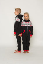Load image into Gallery viewer, Sofa Killer black unisex kids onesie Nordic worn by a boy and girl, featuring red cuffs and a white zipper, showcasing a cozy family style.
