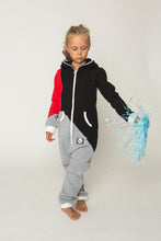 Load image into Gallery viewer, Sofa Killer tricolor unisex kids onesie Racing featuring a model wearing a red-sleeved black and light grey jumpsuit, perfect for playful activities.
