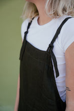 Load image into Gallery viewer, Close-up of the adjustable straps on a linen dark brown color jumpsuit Paloma, showcasing the stylish design.
