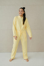 Load image into Gallery viewer, Sofa Killer lime yellow linen women's onesie worn by a smiling model, showcasing its comfy and stylish fit, perfect for summer outings.
