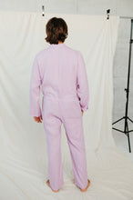 Load image into Gallery viewer, Back view of a man in Sofa Killer violet color linen onesie, showcasing the relaxed fit and design from behind, set against a soft background.
