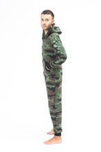Load image into Gallery viewer, Sofa Killer men onesie with camouflage pattern CAMO, displayed on a model in a side view, emphasizing the overall fit and camouflage details.
