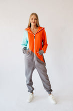 Load image into Gallery viewer, Full view of the Sofa Killer tricolor onesie Jordan, showcasing the stylish mint, orange, and stone grey colors, perfect for relaxed outings.
