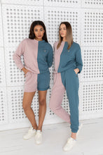 Load image into Gallery viewer, Two women wearing Sofa Killer two color women lounge wear with shorts option in pink and blue, posing against a textured white background.
