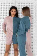 Load image into Gallery viewer, Back view of two women modeling Sofa Killer two color lounge wear, featuring pink and blue colors, highlighting the stylish design.
