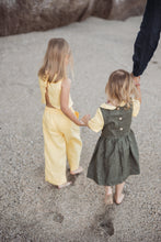 Load image into Gallery viewer, Sofa Killer linen yellow girl set showing two small girls holding hands while walking on the beach, the girl in yellow has a soft linen outfit and the other wears a green linen dress.

