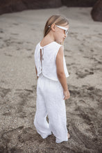 Load image into Gallery viewer, Sofa Killer linen white girl set showcased on a beach, featuring a young girl wearing a stylish white linen top and trousers with sunglasses, perfect for special occasions and family photoshoots.
