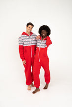 Load image into Gallery viewer, Couple in Sofa Killer red onesie with Nordic applications, smiling and posing together, highlighting the onesie's fun and stylish look.
