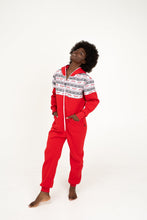 Load image into Gallery viewer, Sofa Killer red onesie with Nordic applications worn by a woman in a relaxed stance, emphasizing its festive pattern and comfortable design.
