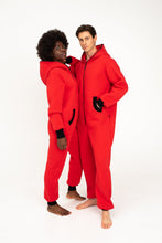Load image into Gallery viewer, Young couple displaying their Sofa Killer red onesies with black zippers, emphasizing comfort and style in casual wear.
