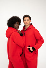 Load image into Gallery viewer, Close-up of a young couple in Sofa Killer red onesies with black zippers, capturing their fashionable look and cozy appeal.
