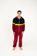 Load image into Gallery viewer, Front view of a model wearing Sofa Killer men velour onesie California in bordo with a zip-up design.
