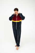 Load image into Gallery viewer, Different angle of the model in the Sofa Killer Kansas velour onesie, highlighting its soft texture and cozy fit, ideal for relaxed weekend wear.

